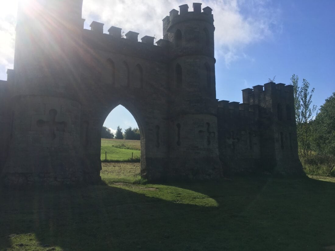 A castle gate with green field on the background. 