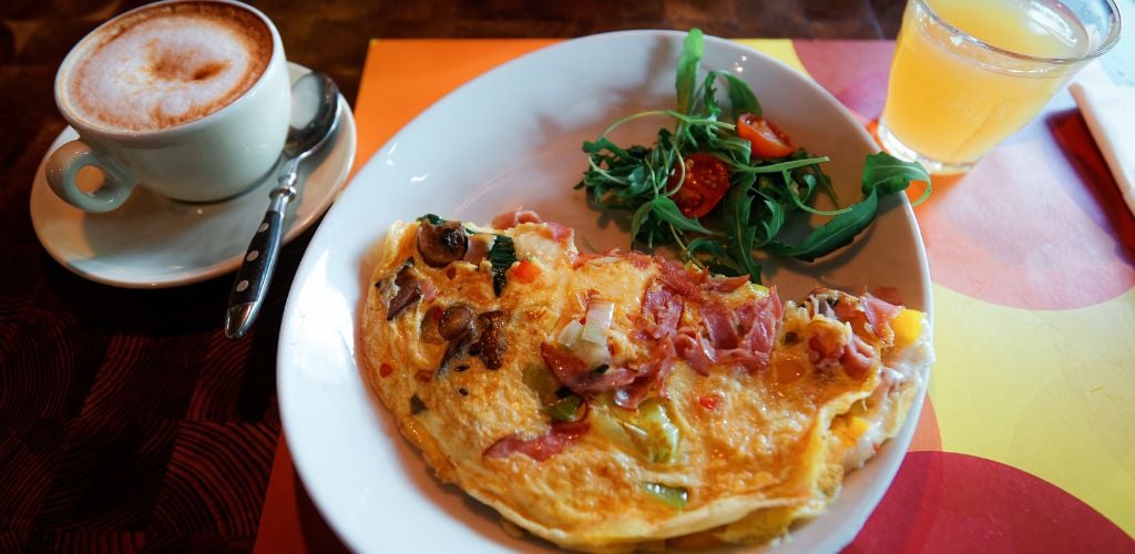 Breakfast with Omelette cup of coffe and juice