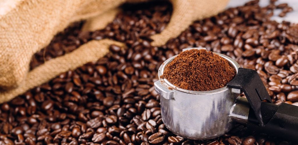 Coffee Beans and Portafilter with Roasted Coffee Ground