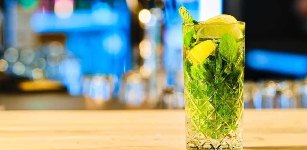 A close-up shot of Classic Cold Cocktail Mojito at the bar counter. 