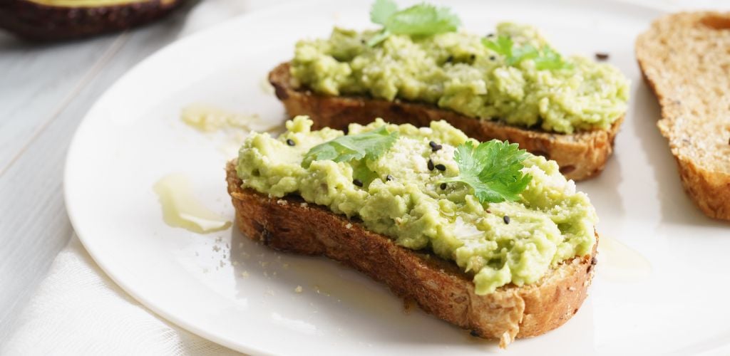 Healthy breakfast toast with an avocado smash. 