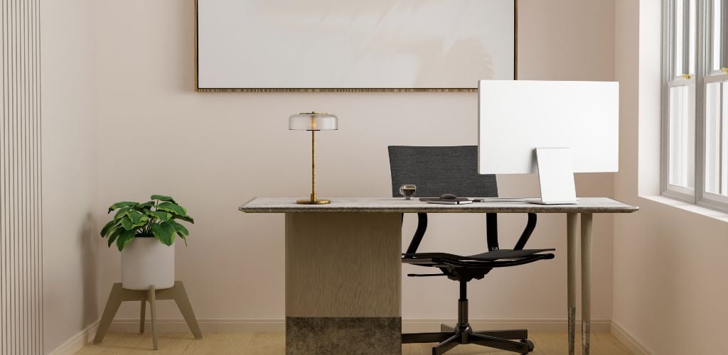 Modern minimal bright office workspace in a private office room with a personal computer and accessories on the table, office chair, indoor plant, and mockup frame on a white wall.