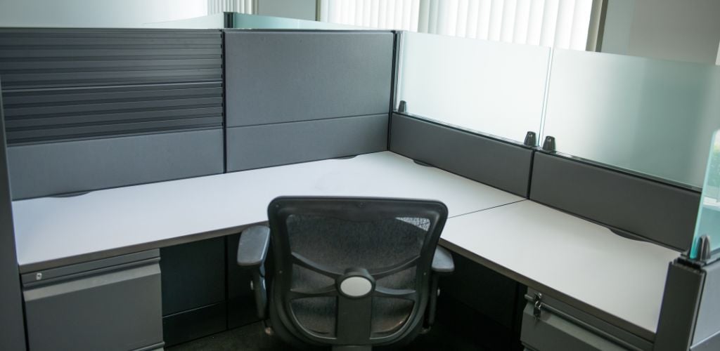 office cubicle with desk and chair. 