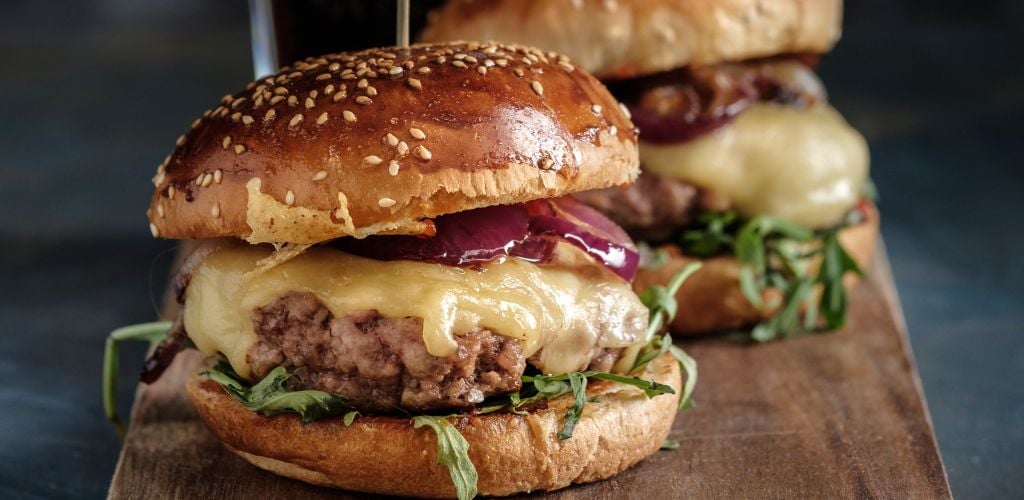 Homemade juicy burger with beef, cheese and caramelized onions. 