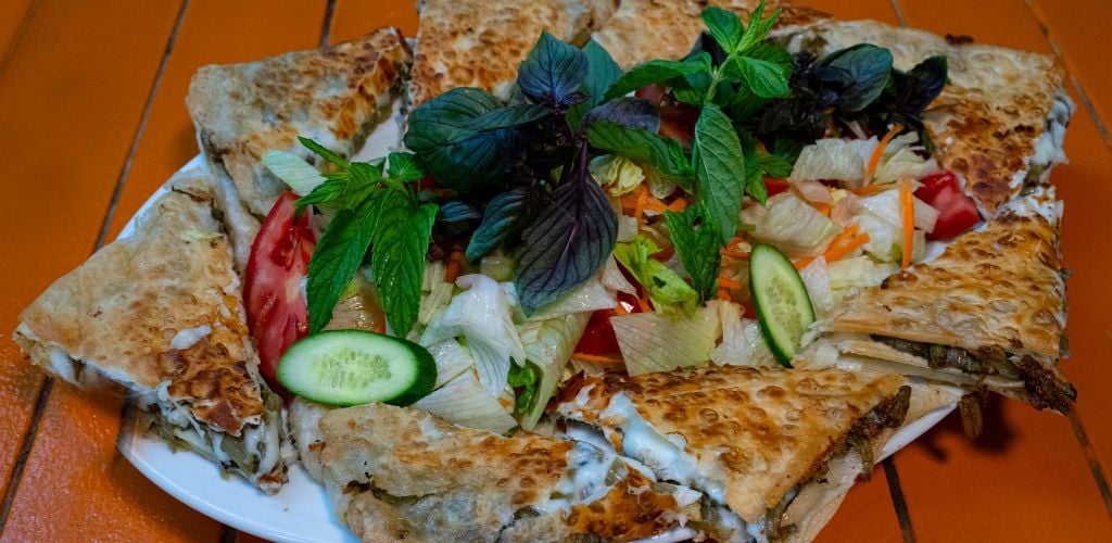 "Gözleme" is a traditional Turkish snack and Breakfast meal on a wooden table. 