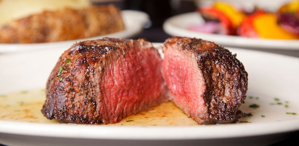 A close up of a steak on a dinner table. 