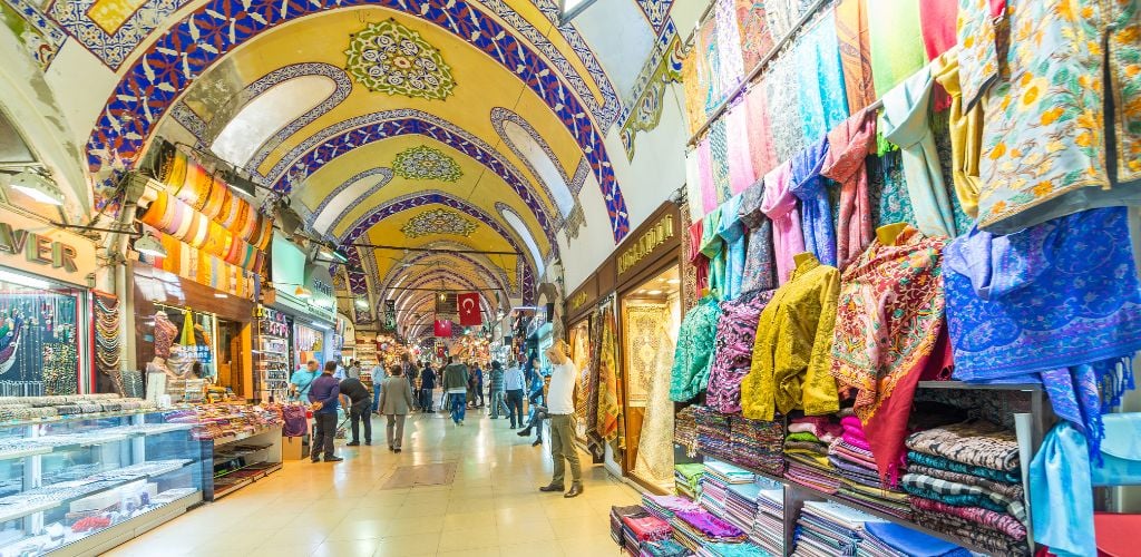 An indoor bazaar and a dome ceiling shape. Selling a beautiful and colored fabric. 