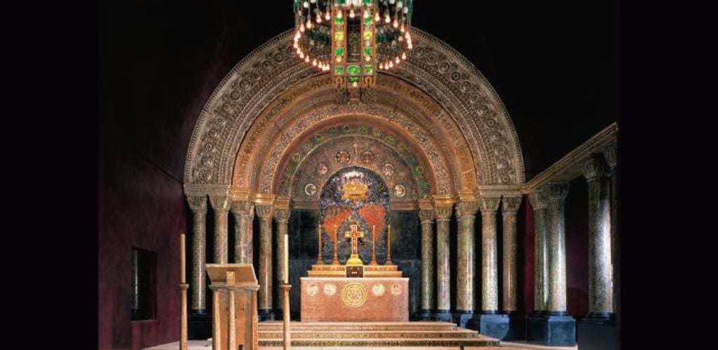 A stunning altar with a circular chandelier.