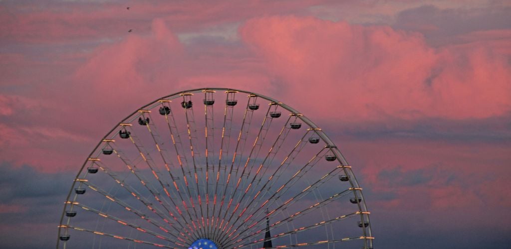 A Ferris wheel at the sunset. 