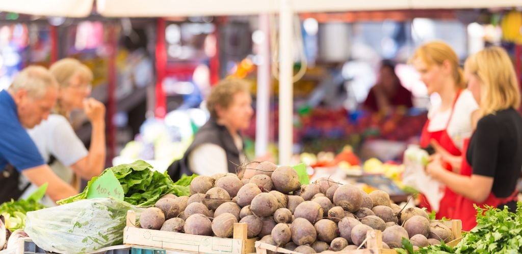 Farmers' market stall with a variety of organic vegetables. 