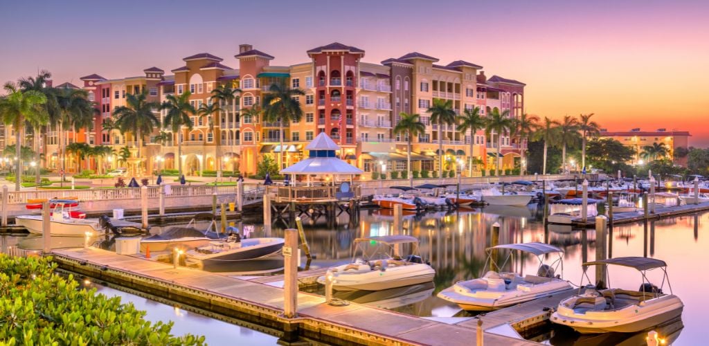 Naples, Florida, USA town skyline on the water at dawn. 