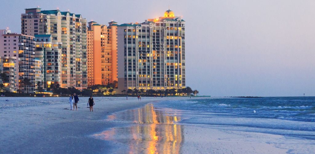Marco island beach ocean front building shoot at dusk, big reflection on wet sand. 