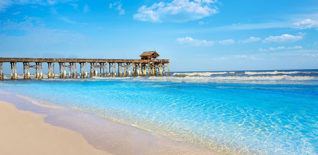 The Cocoa Beach Pier, the clear blue sea, and the clear sky. 