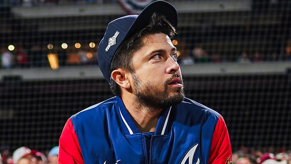 Travis d'Arnaud looks on field from dugout