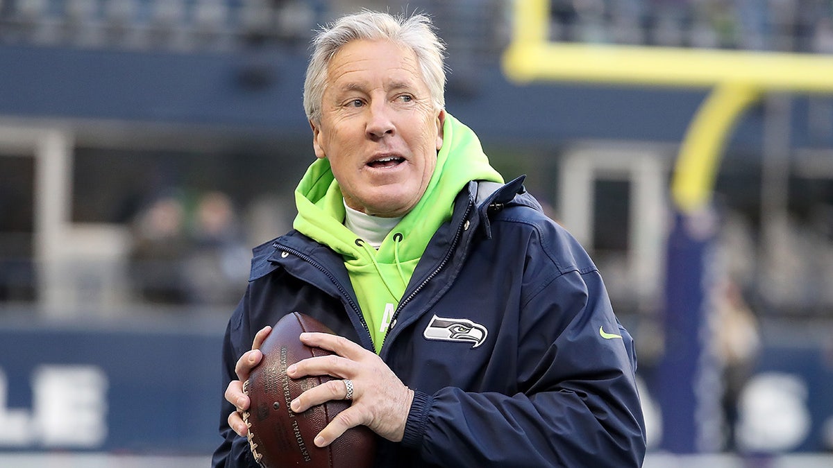 Pete Carroll of the Seattle Seahawks throws the ball