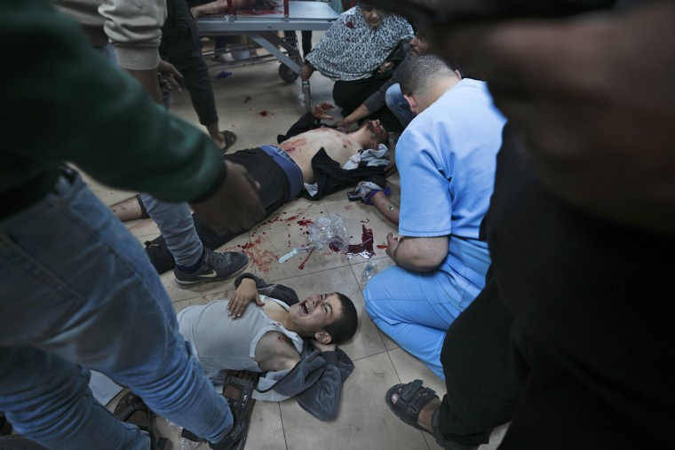 Wounded Palestinians are treated at Al-Aqsa hospital in Deir al Balah, centeral Gaza Strip, Sunday, Jan. 7, 2024. 