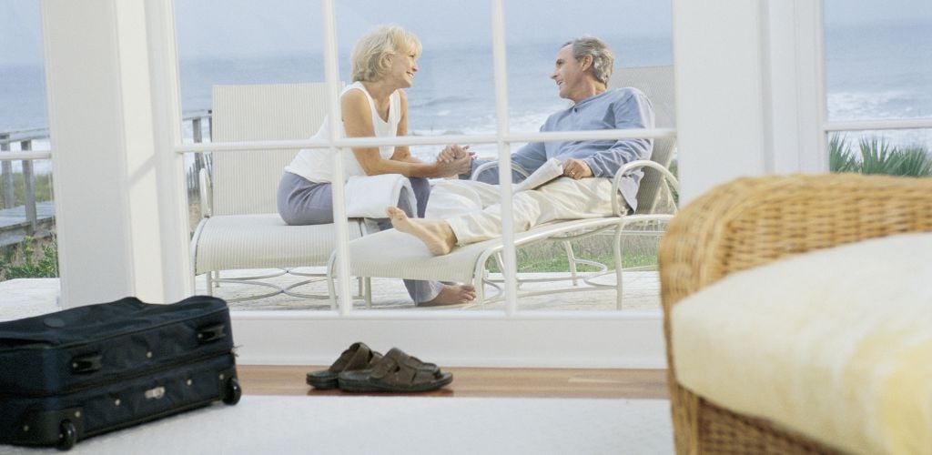 Couple sitting outdoors at beach house