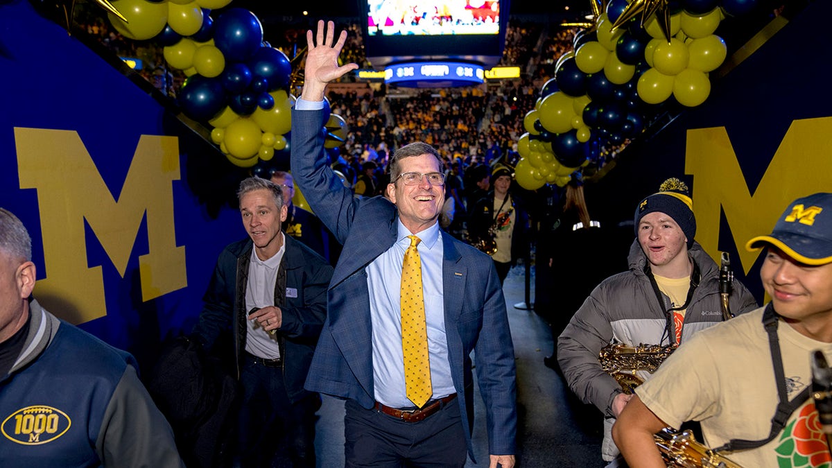 Jim Harbaugh waves