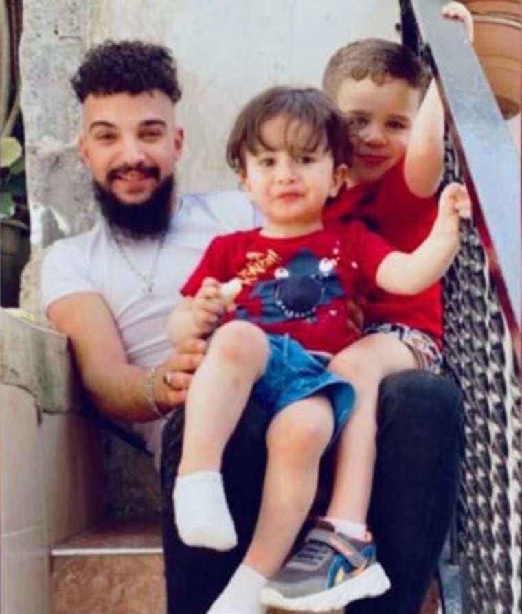 Abdel Rahman Al Bhash sitting with family members. Bahsh died in an Israeli prison on New Year's Day.