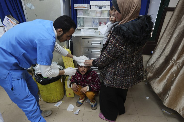 A wounded Palestinian child is brought to Al Aqsa Hospital in Deir al Balah, Gaza Strip, on Thursday, Jan. 11, 2024.