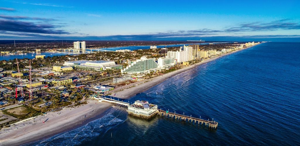 Aerial View of Daytona Beach, Florida FL. View of hotels, amusement park, trees, and beach. 