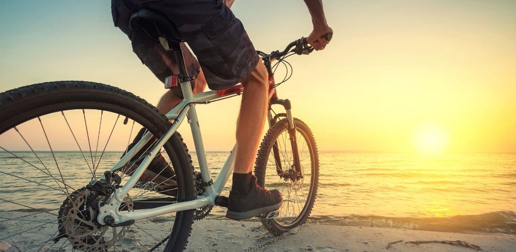 Ride on bike on the beach. Sport and active life concept. 