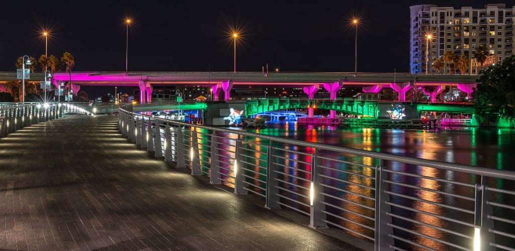 This is a nighttime photo of one of the many lighted bridges and walkways along Tampa's Riverwalk. 
