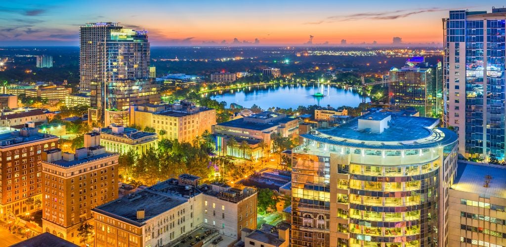 Orlando, Florida, USA aerial cityscape towards lake Eola at dusk. 