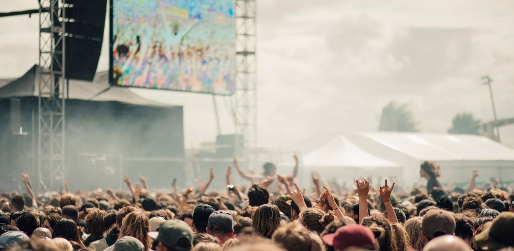 A crowd has fun at a music festival.