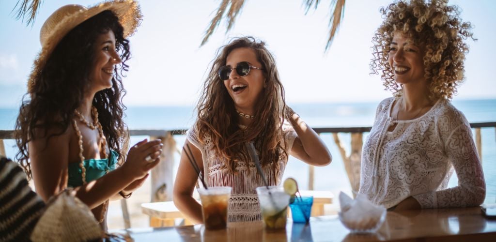 Three beautiful girls in a bar on the beach.