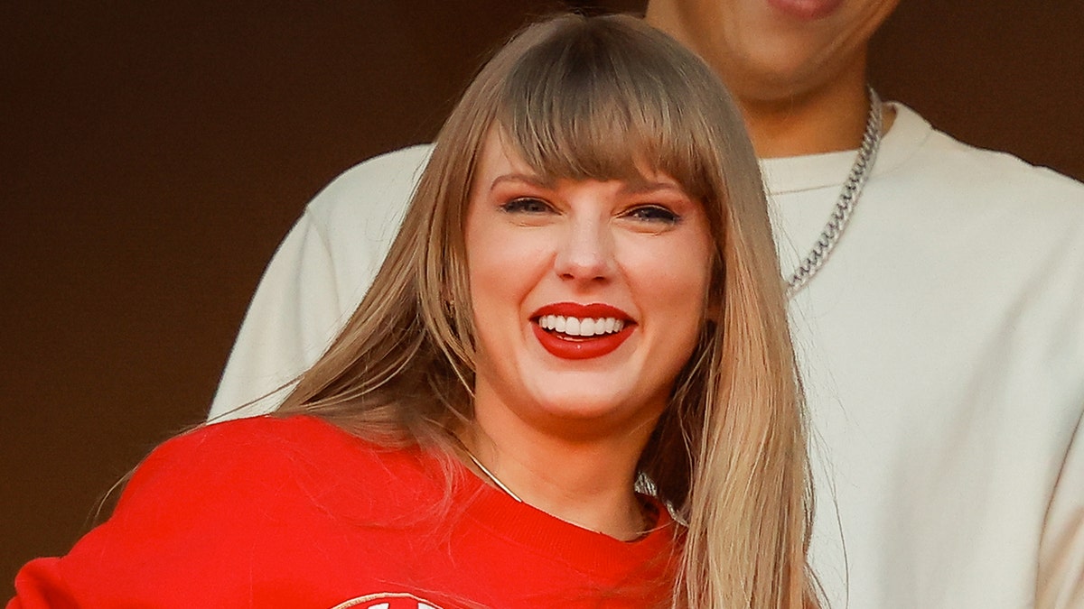 Taylor Swift smiles during Kansas City Chiefs football game with Travis Kelce