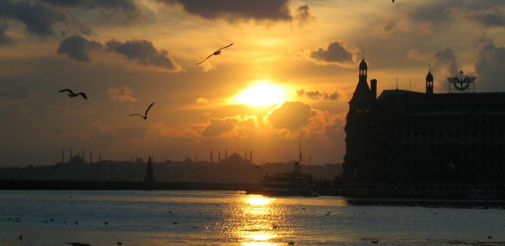 Cityscape at sunset from Kadikoy Istanbul towards Sultanahmet. On the right side, there is a Haydarpasa train station. 