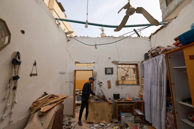 A man inspects the damage in a house following Israeli bombardment in Rafah, Gaza, on Feb. 12, 2024.