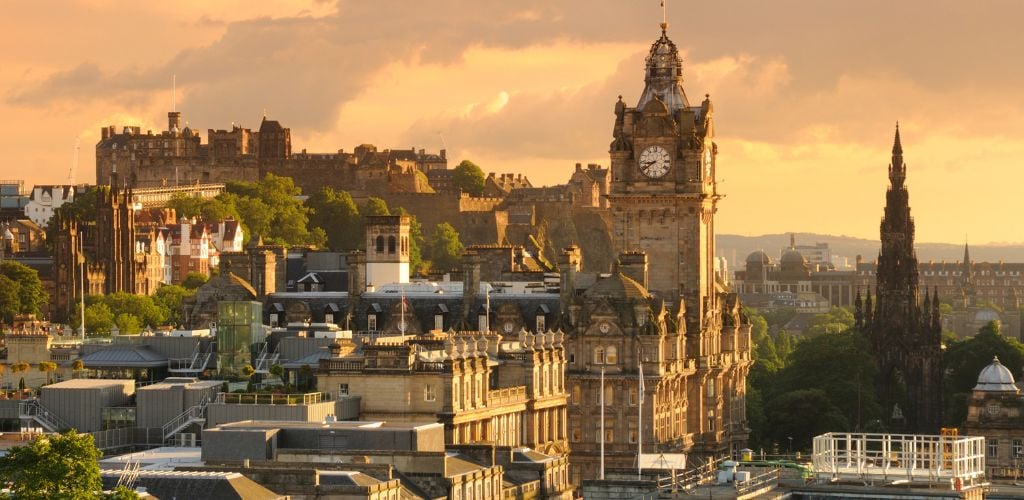 When viewed from above, the large clock tower and other historic buildings in the sunset may be seen. 