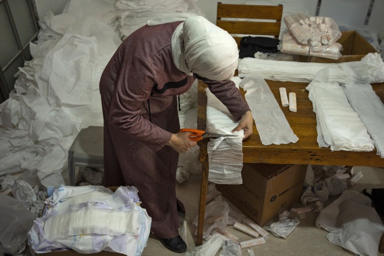 A Palestinian woman sews diapers in Rafah, southern Gaza Strip, Thursday, Feb. 15, 2024. 
