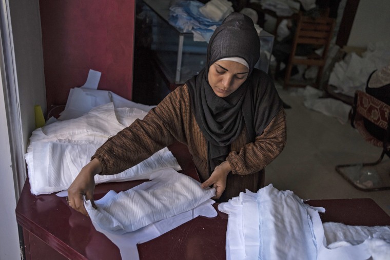 A Palestinian woman sews diapers in Rafah, southern Gaza, Feb. 15, 2024.