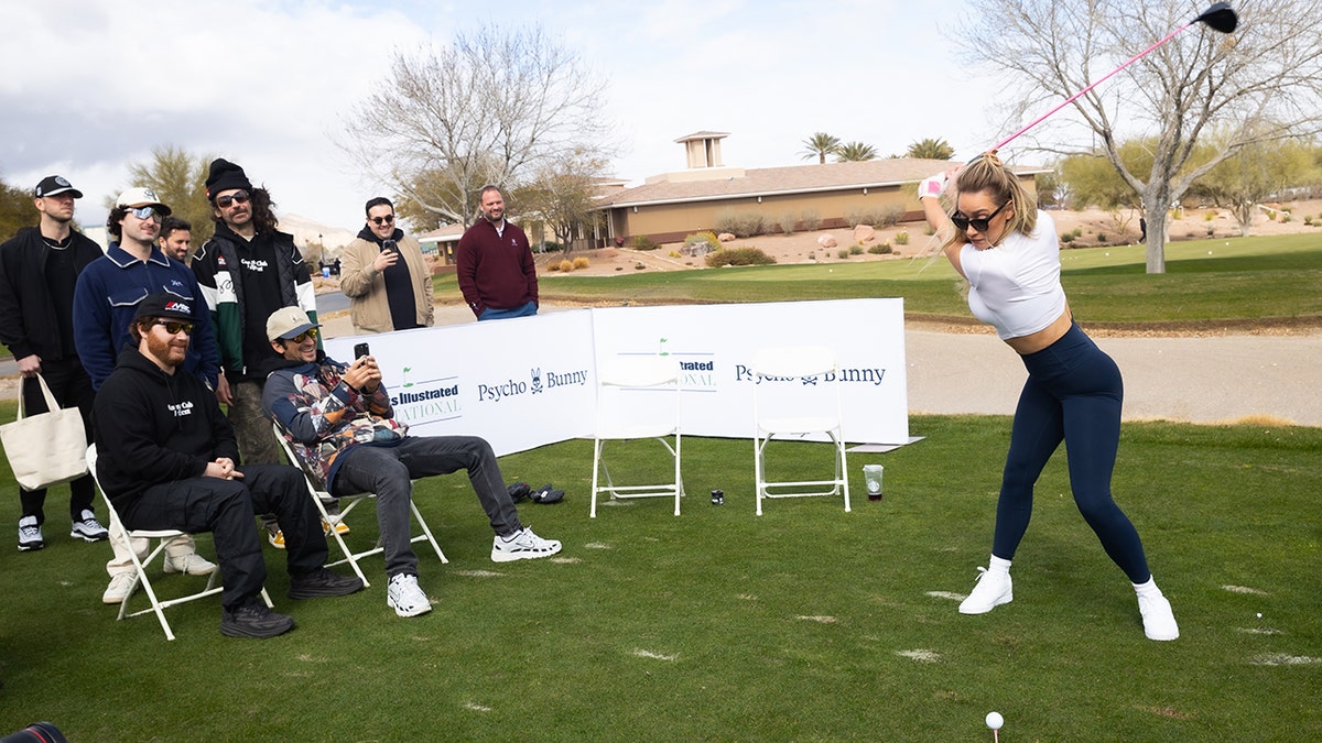 Paige Spiranac swings club