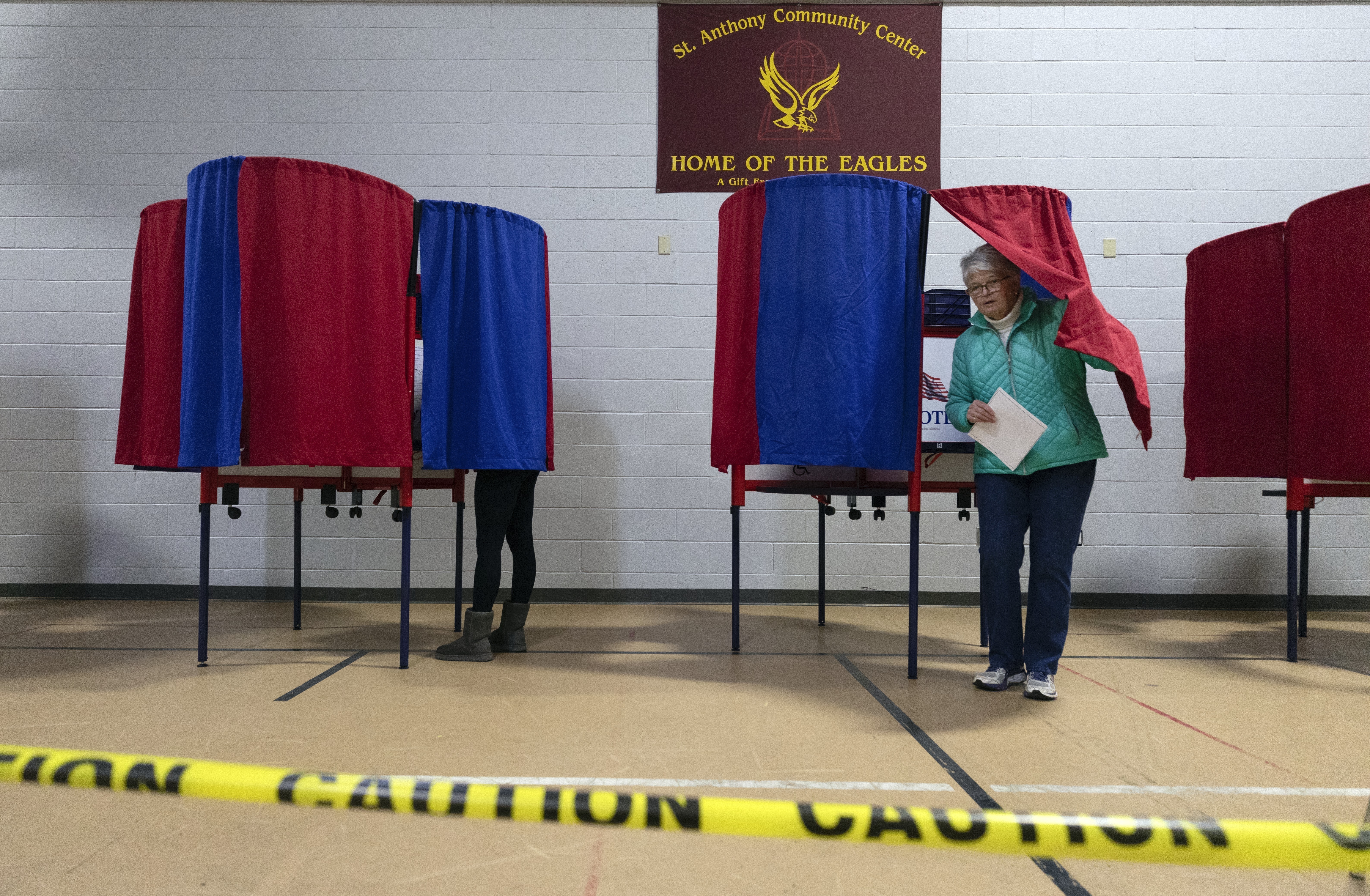 A voter leaves a polling booth at St. Anthony Community Center in Manchester, N.H., during the state