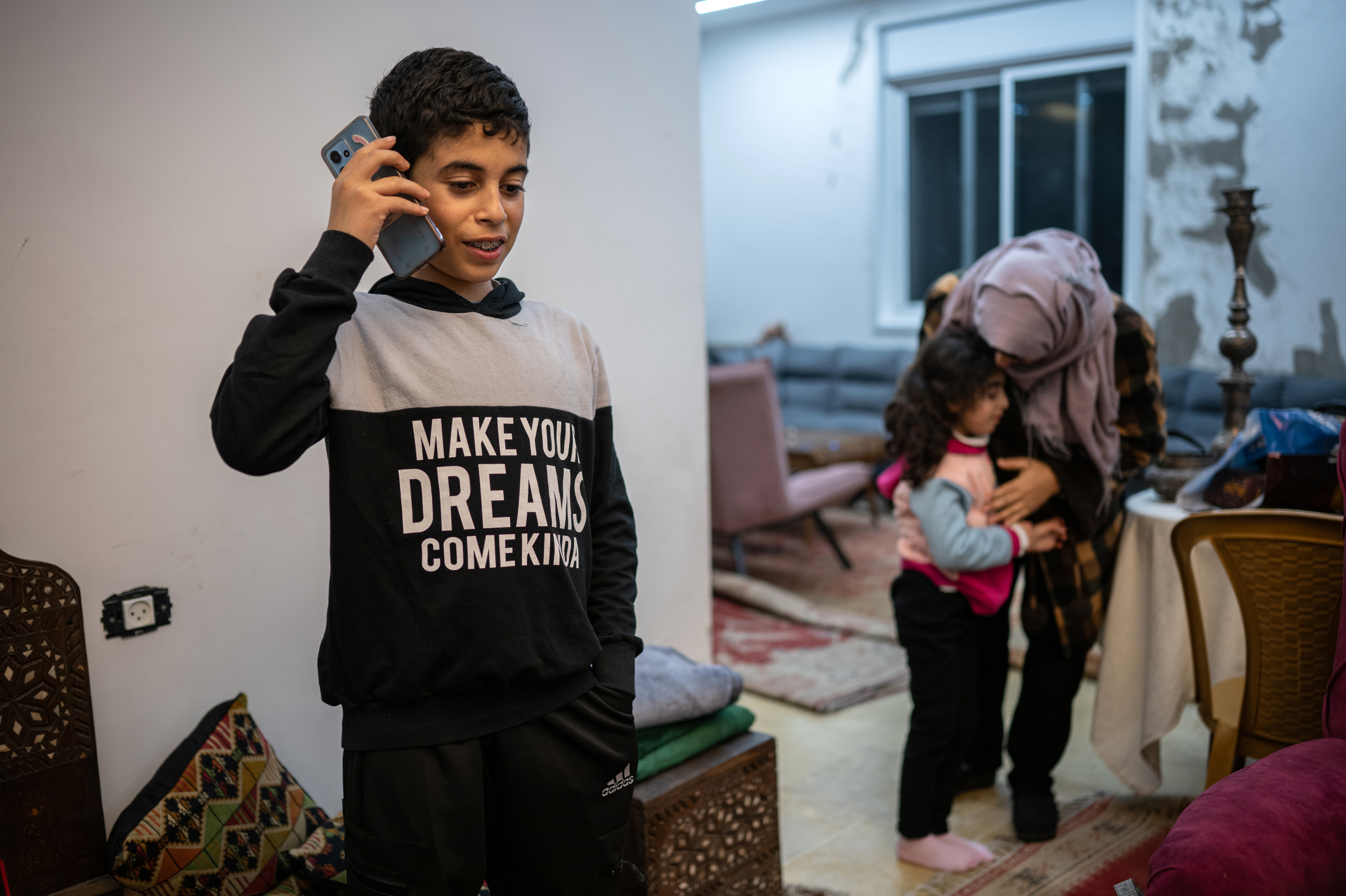 Ibrahim, 12, speaks to his grandmother, who lives in Gaza, from his home in Ramallah in the Israeli-occupied West Bank on Jan. 31. The family did not want to use their full names out of fear of reprisals from Israeli authorities.