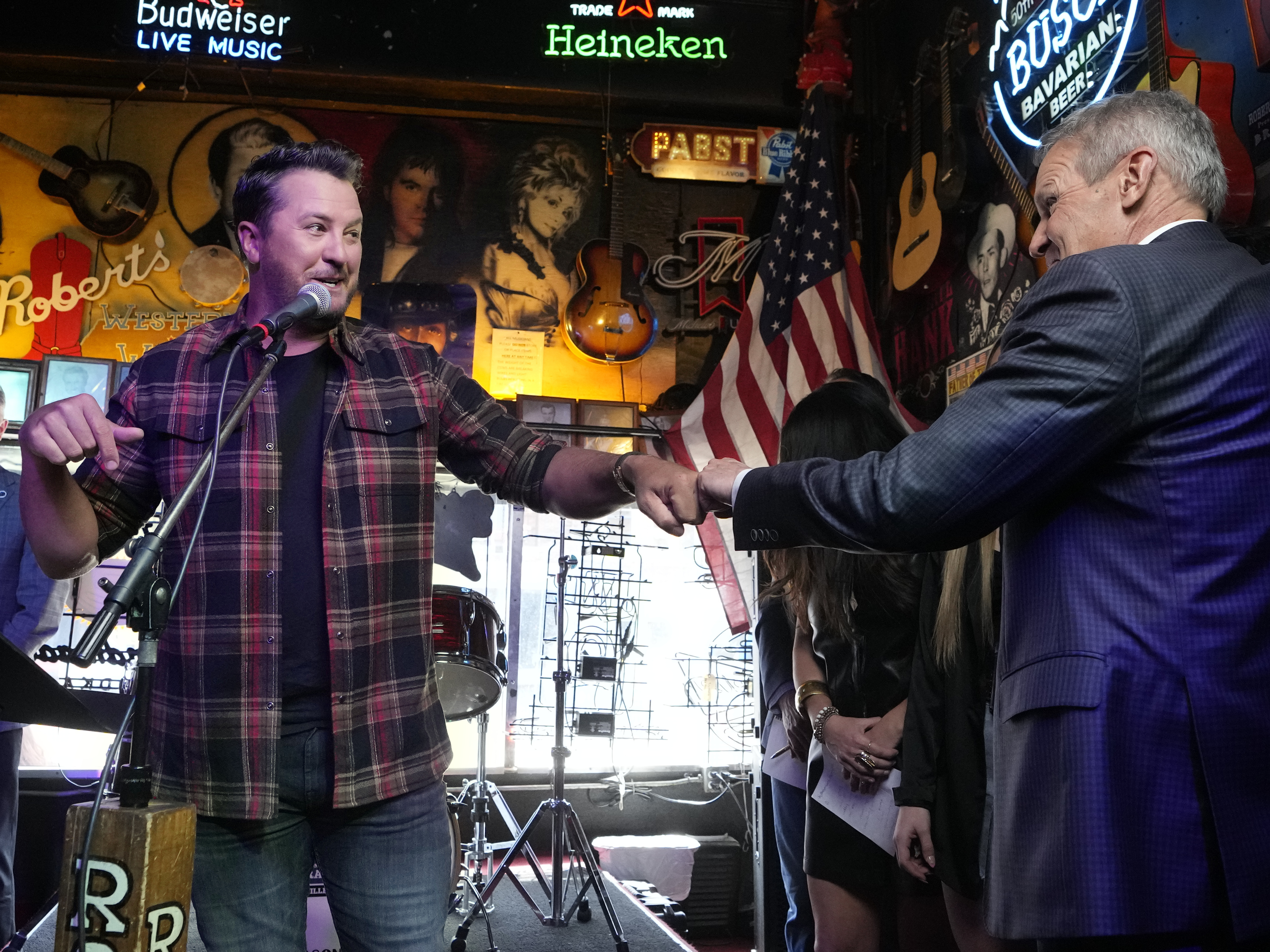 Country music star Luke Bryan gives a fist bump to Gov. Bill before Lee signed a bill Thursday, March 21, 2024, in Nashville, Tenn.