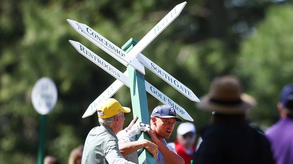 Bryson DeChambeau lifts sign