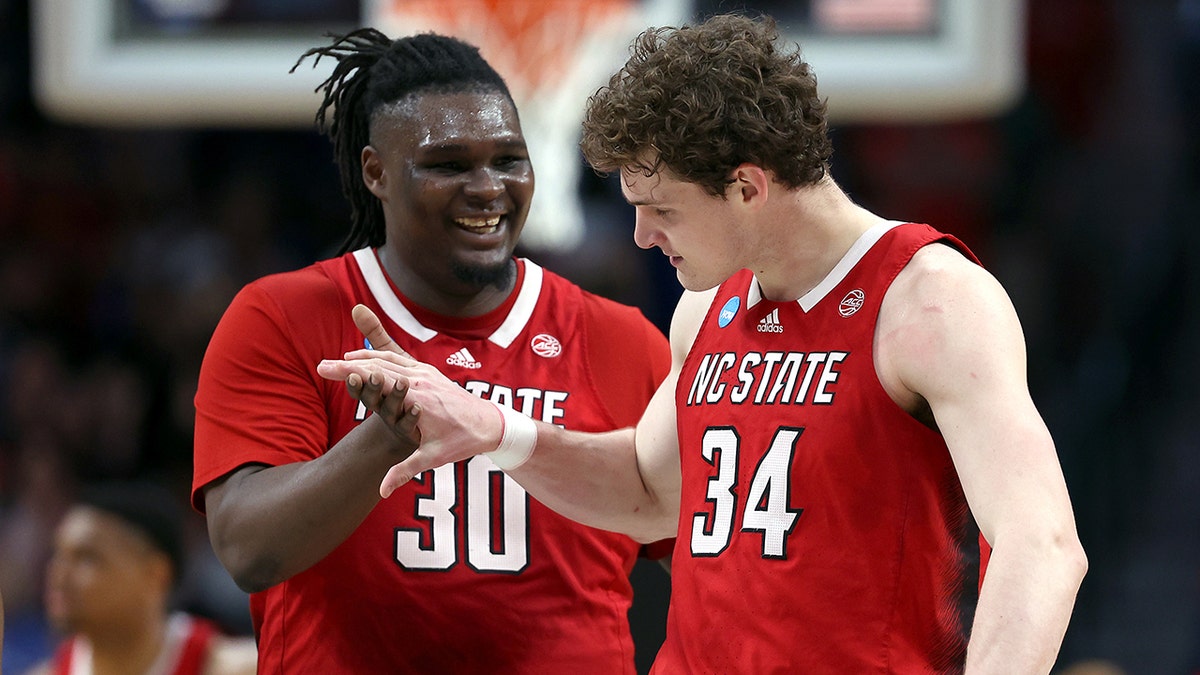 DJ Burns Jr. and Ben Middlebrooks celebrate on court