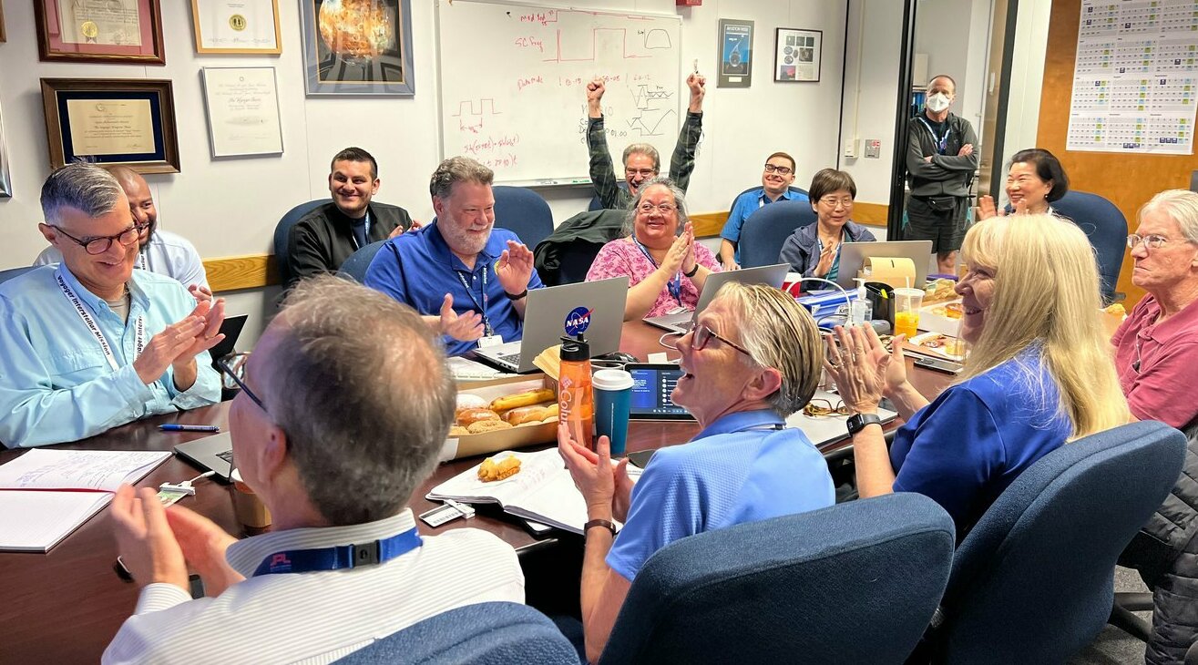 Members of the Voyager team celebrate at NASA