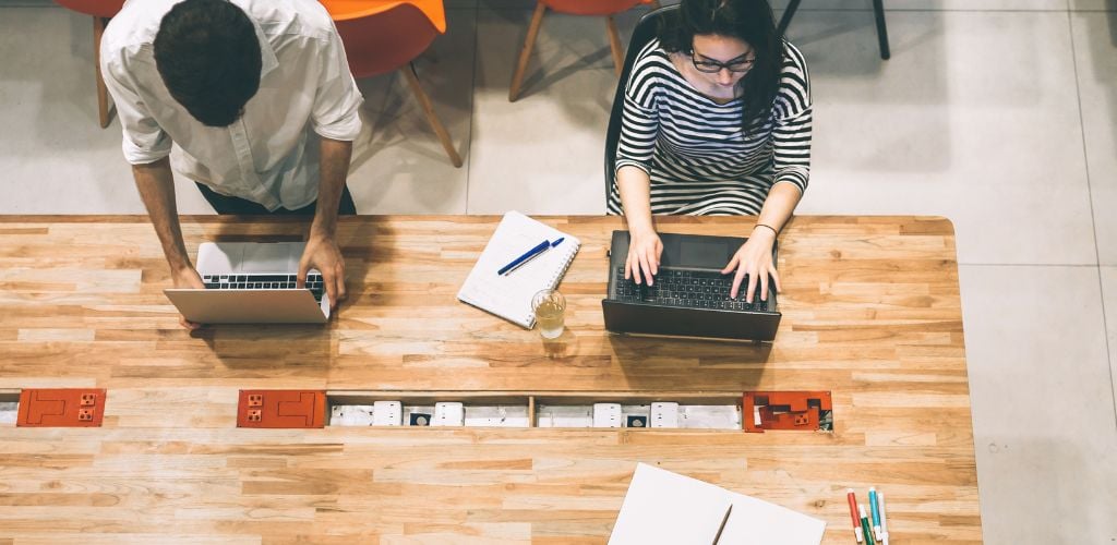 coworking space, people working on laptops 