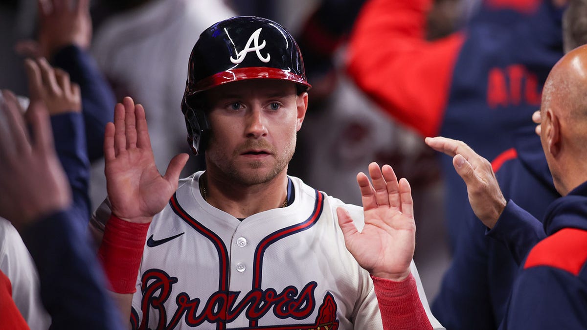Jarred Kelenic high-fives teammates