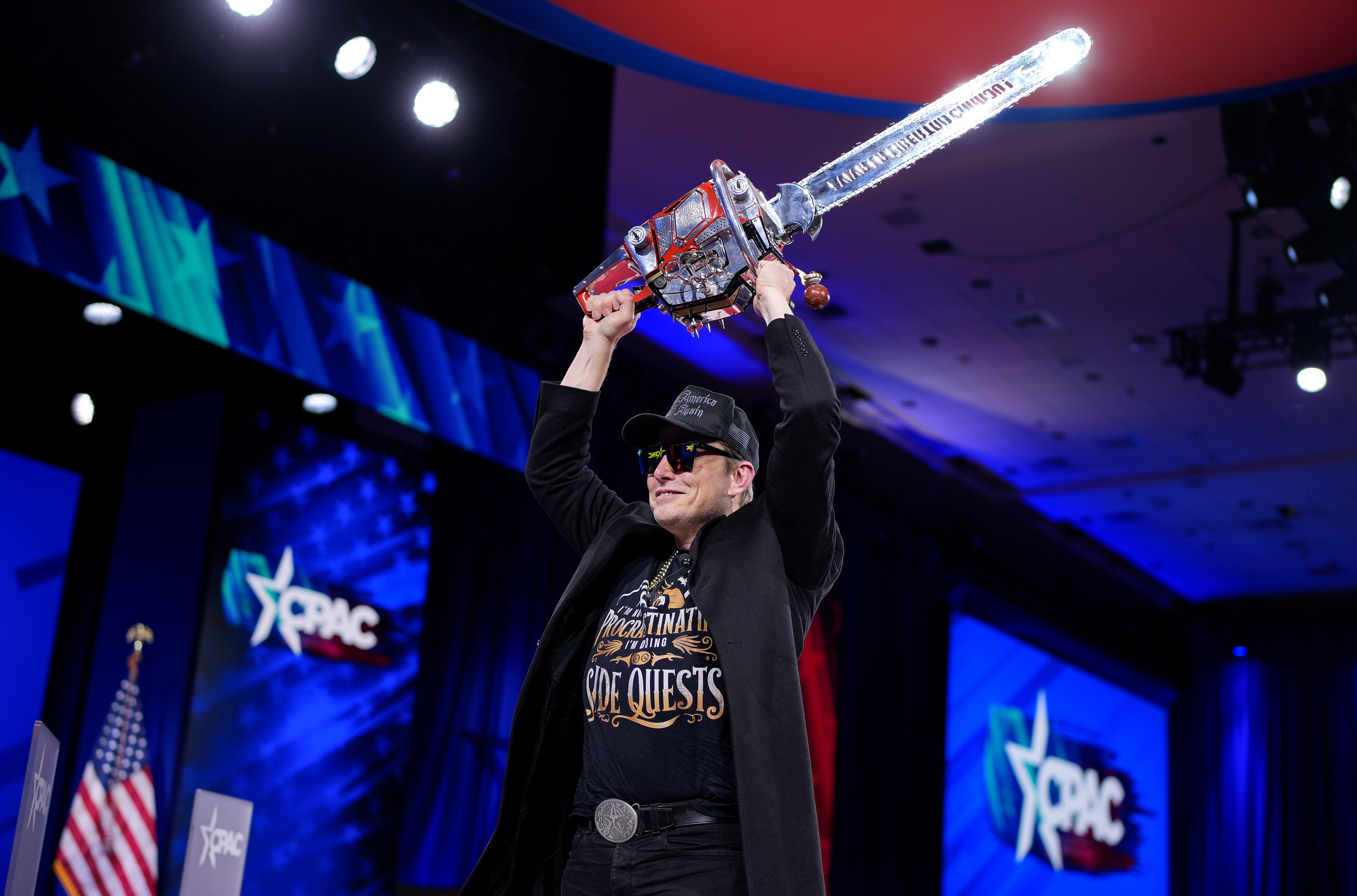 Elon Musk wields a chainsaw at the Conservative Political Action Conference on Feb. 20 in Oxon Hill, Md.