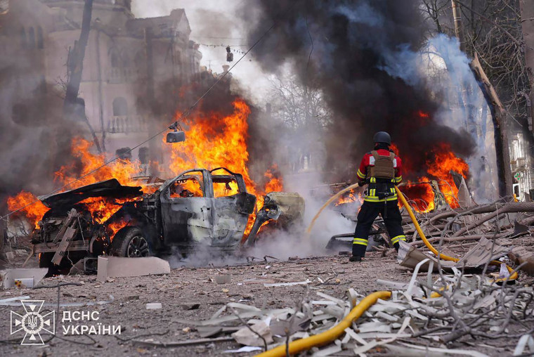 A firefighter battles a blaze at the site of a missile attack in Sumy, Ukraine