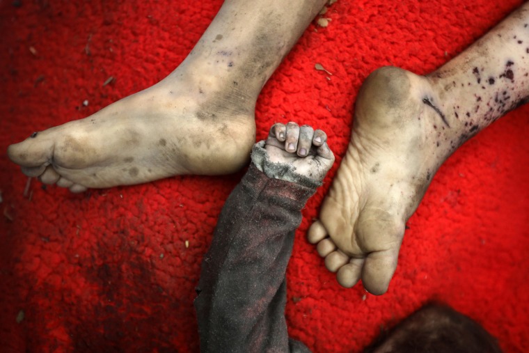 The bodies, image shows two feet and a hand, of two Palestinian children killed in an Israeli airstrike