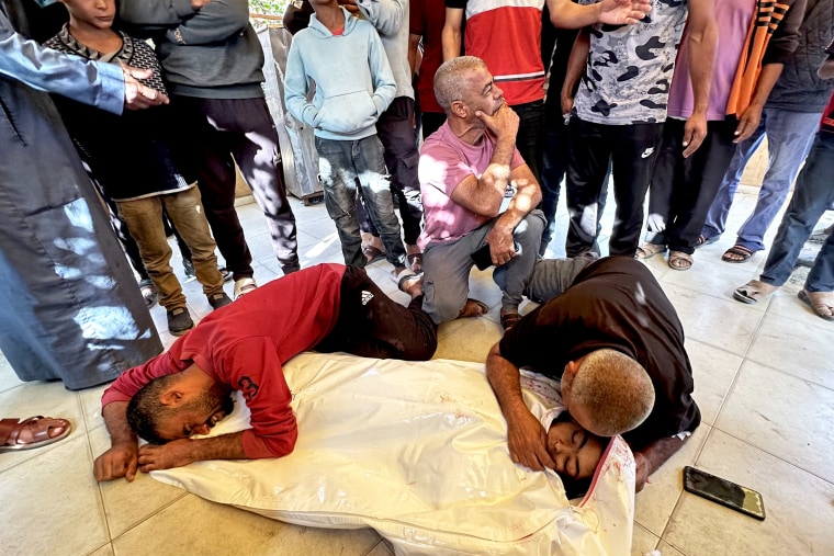 Ashraf's family members mourn as they prepare to bury the 10-year-old.