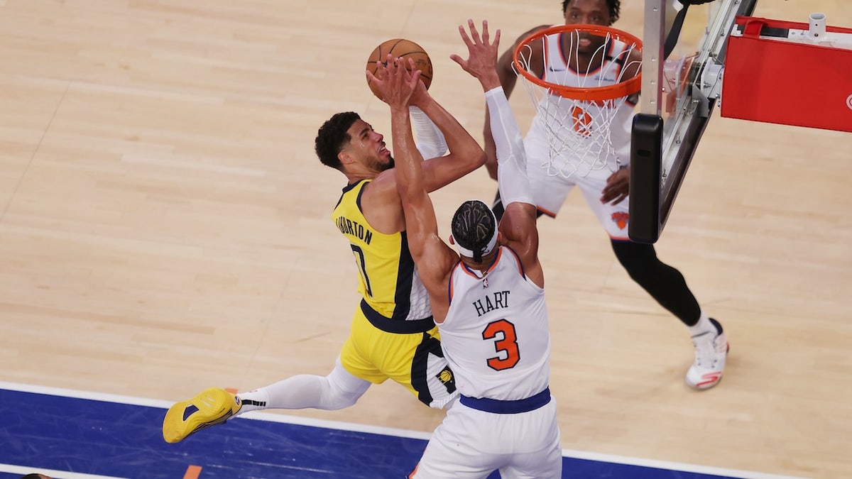 May 21, 2025; New York, New York, USA; Indiana Pacers guard Tyrese Haliburton (0) shoots against New York Knicks guard Josh Hart (3) in overtime during game one of the eastern conference finals for the 2025 NBA Playoffs at Madison Square Garden. Mandatory Credit: Brad Penner-Imagn Images